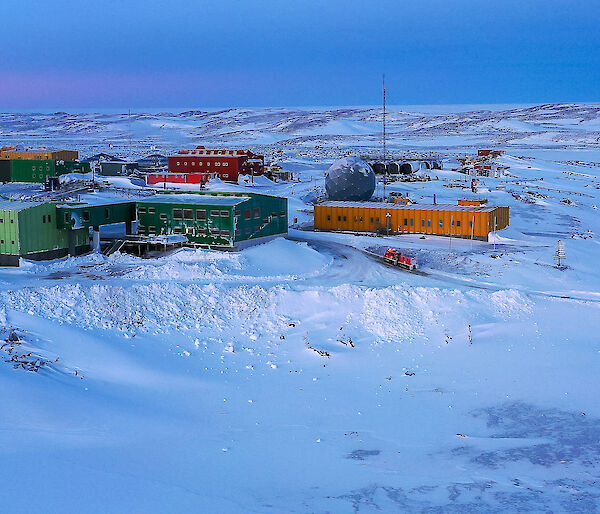 Colourful buildings in a snowy landscape.