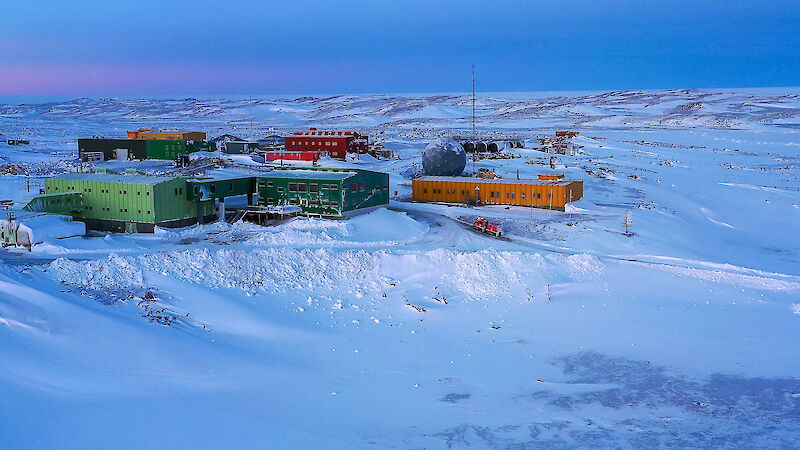 Colourful buildings in a snowy landscape.