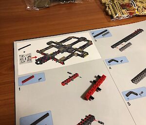 Pages of an Lego instruction manual showing the first couple of steps in the building process.