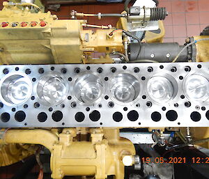 Looking down in to a generator with a clean and shiny engine part displayed