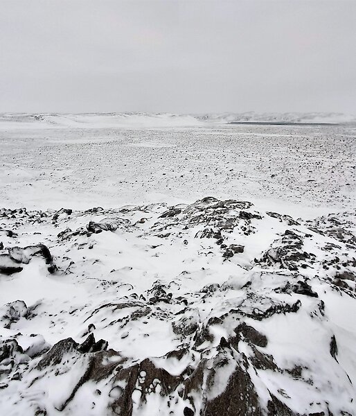 a rocky landscape covered in snow