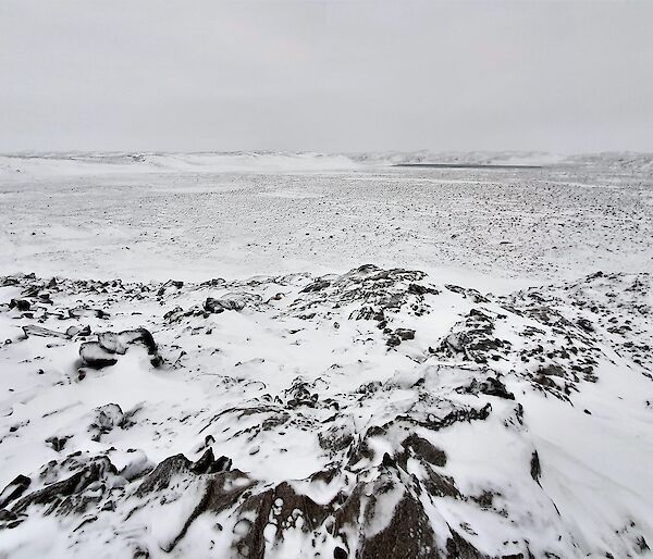 a rocky landscape covered in snow