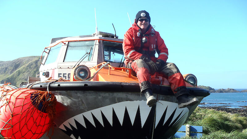 Man sitting on LARC with painted teeth on the bow