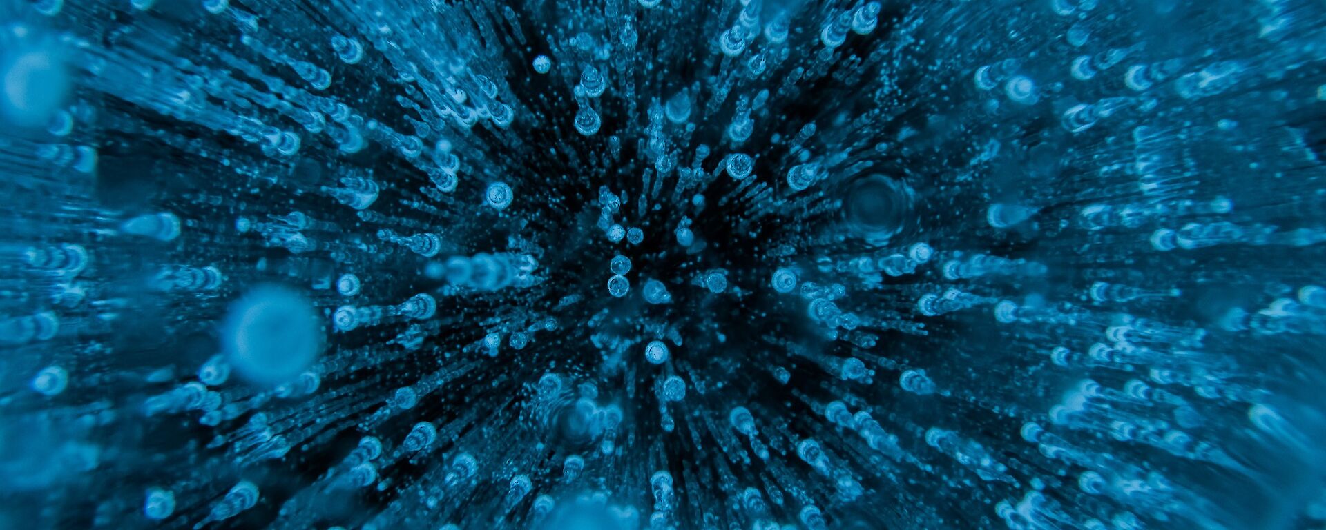 A close up of frozen water showing hundreds of air bubbles trapped in the ice