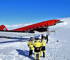 Group stand with an aircraft at snow runway.