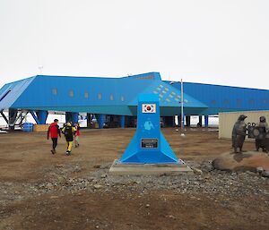Blue building with penguin statues.