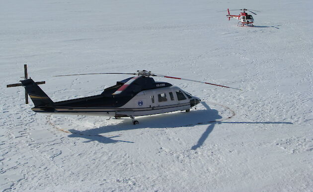 Two helicopters on the ice.