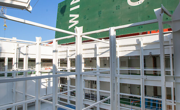 Four shipping containers in a cargo hold.