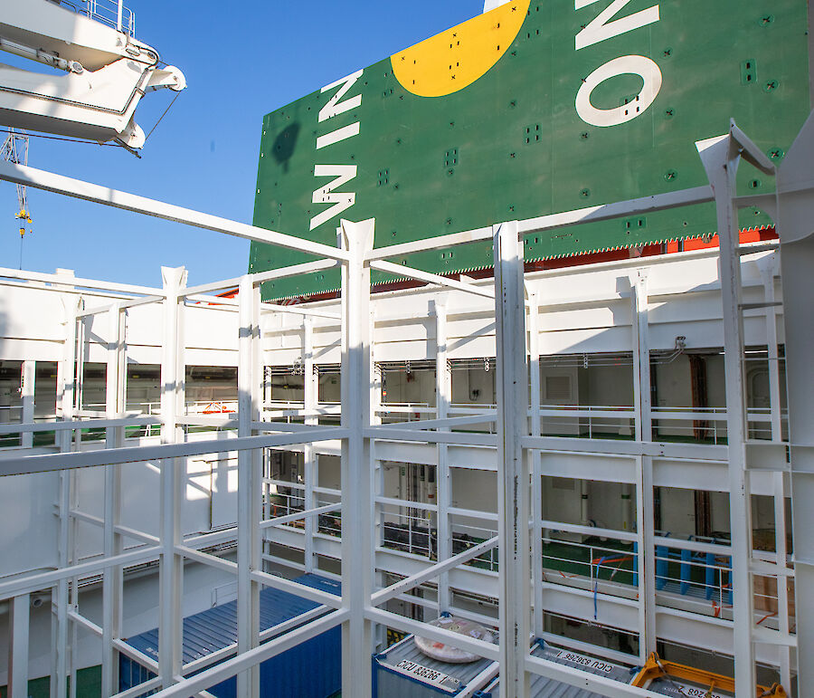 Four shipping containers in a cargo hold.