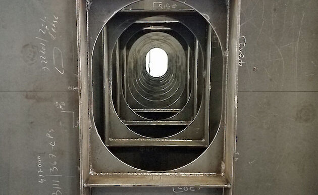 Layers of steel surrounding a port hole.
