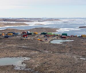 An aerial view of Davis station buildings sitting on rocky ground near the shoreline