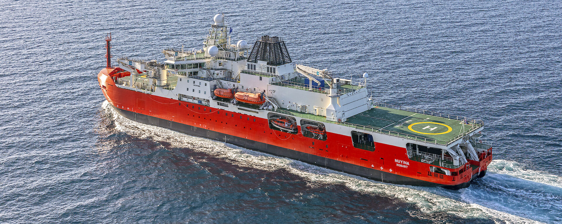Orange and white icebreaker at sea