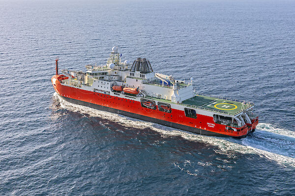 orange and white icebreaker at sea
