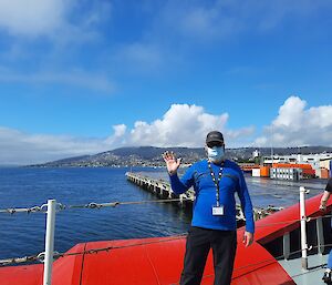 Simon standing on the deck ship in Hobart as it pulls away from the Hobart wharf.