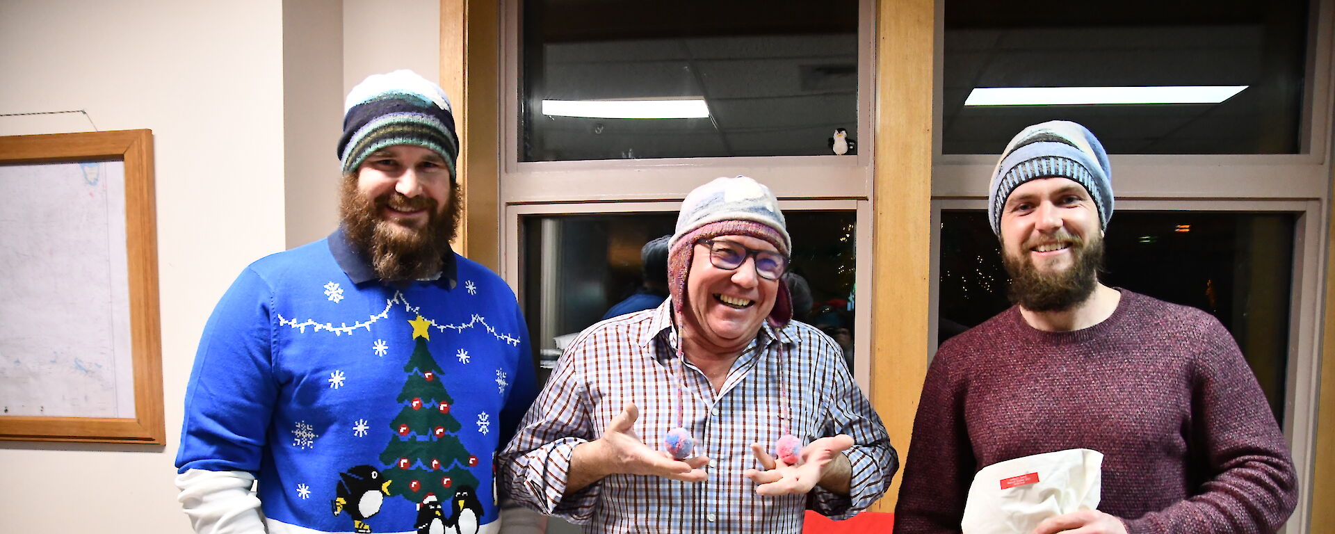 Three expeditioners all wearing their hat knitted by Hadley.