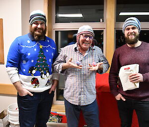 Three expeditioners all wearing their hat knitted by Hadley.