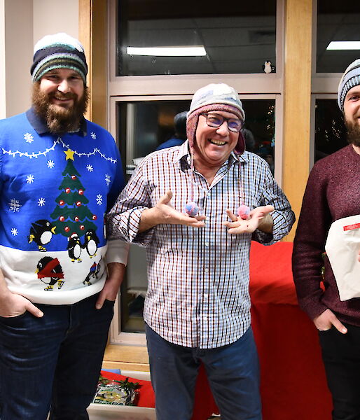 Three expeditioners all wearing their hat knitted by Hadley.