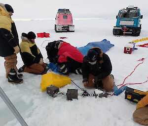 A group of people on the sea ice ready to deploy the mooring