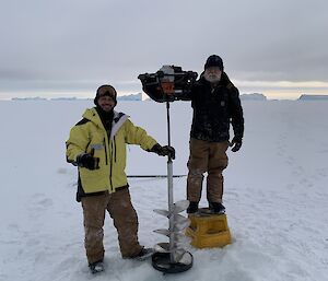 Two men pose with the auger custom made on station for the deployment job