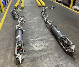 Long acoustic moorings lying on the floor of a warehouse