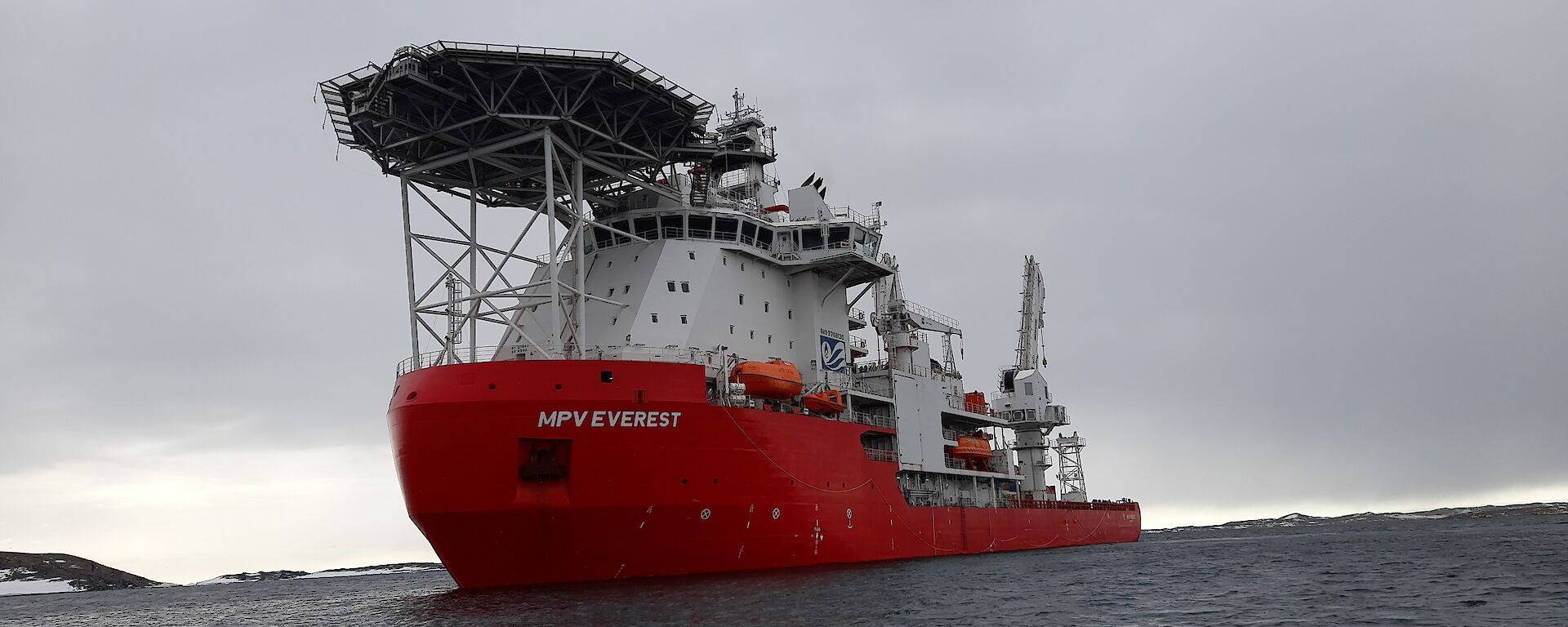 MPV Everest with grey skies behind as viewed taken from a small boat on the water.