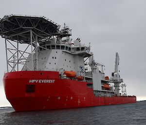 MPV Everest with grey skies behind as viewed taken from a small boat on the water.