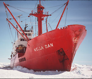 A red icebreaking ship parked in sea ice.