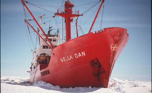 A red icebreaking ship parked in sea ice.
