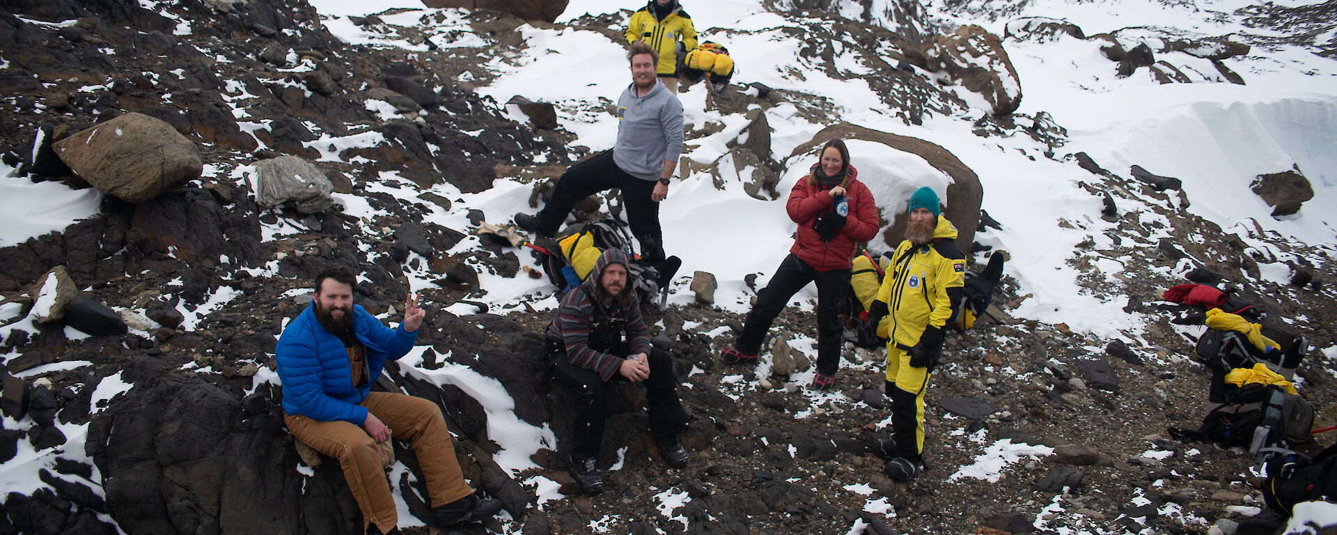 A group of people rest at the top of Stalker Hill smiling to camera.