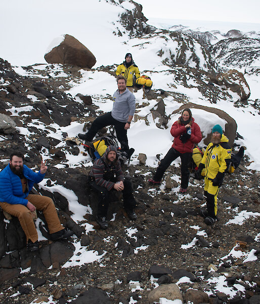 A group of people rest at the top of Stalker Hill smiling to camera.
