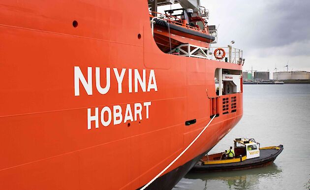 The side of a large red ship that reads Nuyina Hobart