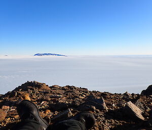 Photos from top of a hill looking over the Plato with a mountain range of in the distance.