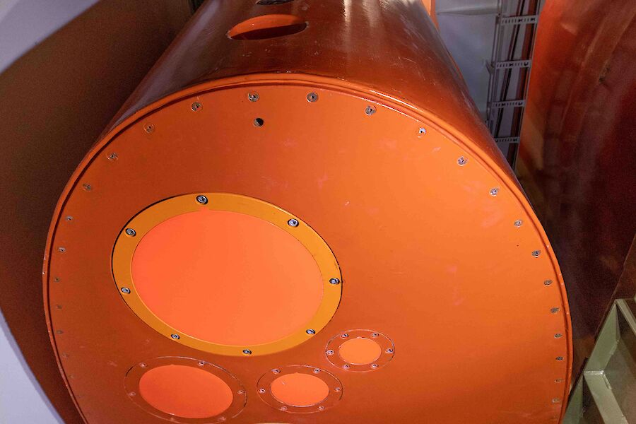 A large orange metal keel housed inside a ship