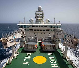 View of the bridge of a large red ship taken from the bow