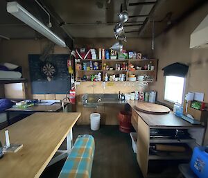 Inside of a field hut, with tables and benches, and a small kitchen after a recent spring clean.