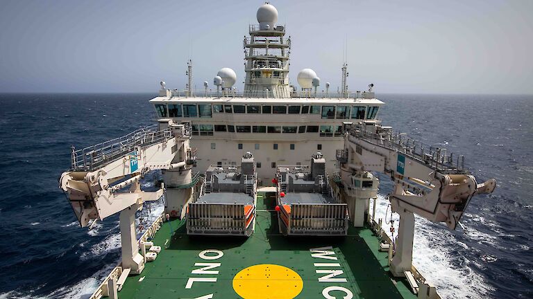 Foredeck of Nuyina showing two main cargo cranes stowed while at sea