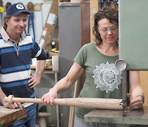 Two people working in a carpenter's workshop