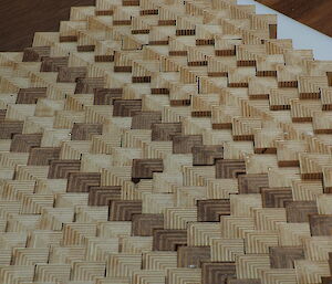 Timber cut in patterned chevrons, to be made into a chair