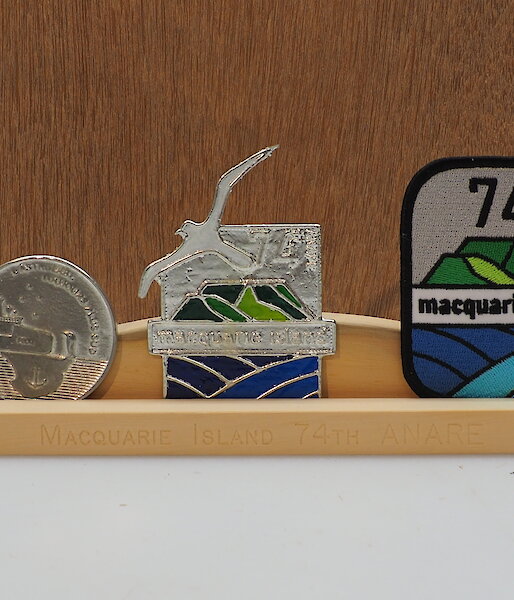 Two medallions and a printed patch on a hand made Huon pine stand