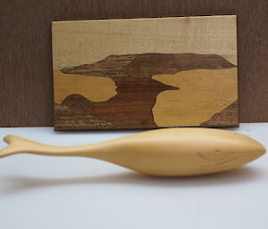A whale and picture made from timber on display