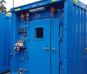 The front of a shipping container showing the points to plug in power, air, water and other services.