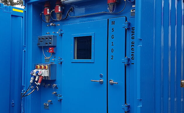 The front of a shipping container showing the points to plug in power, air, water and other services.