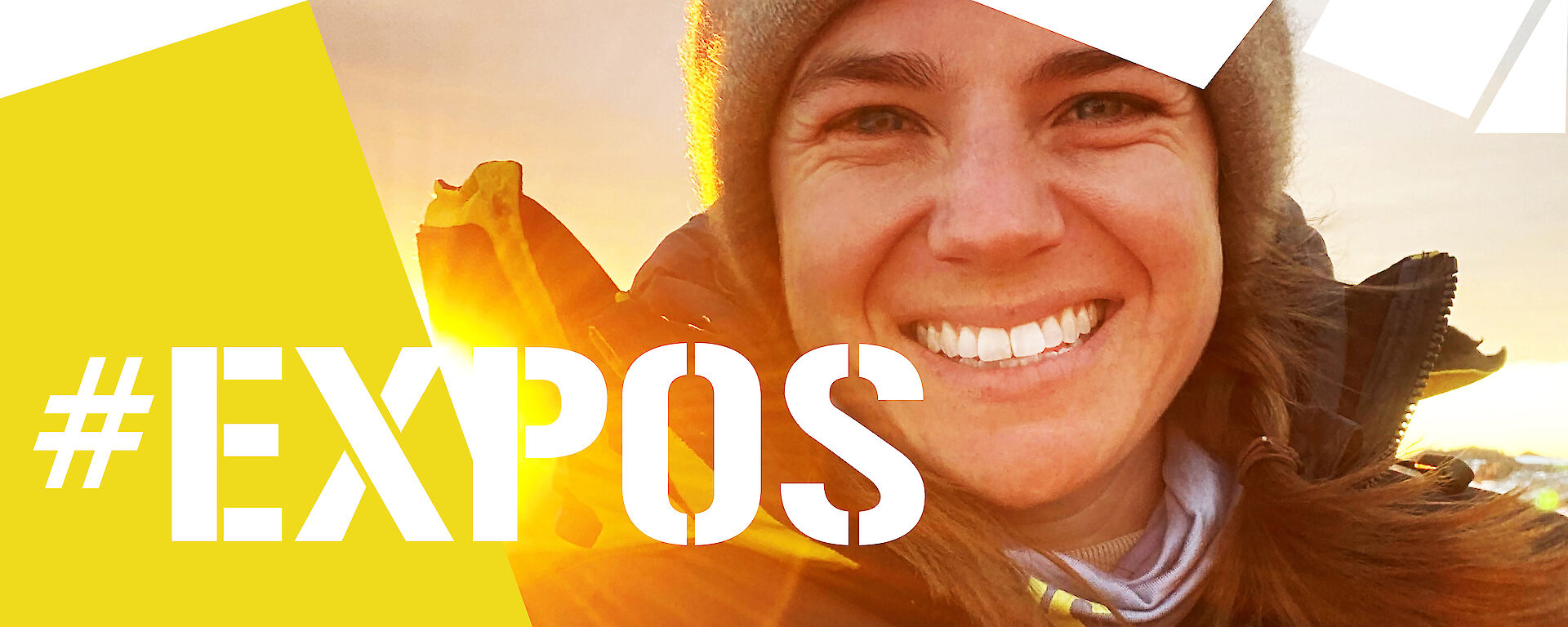 Self portrait of expeditioner Maddie Ovens wearing Antarctic clothing with sun shining over her shoulder. Text: #Expos