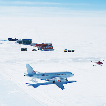 Aerial view of Wilkins Aerodrome with A319 place and helicopter on the runway.