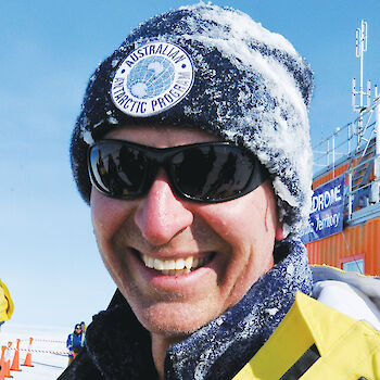 Close cropped shot of Noel Tennant in dark sunglasses and snow covered beanie.