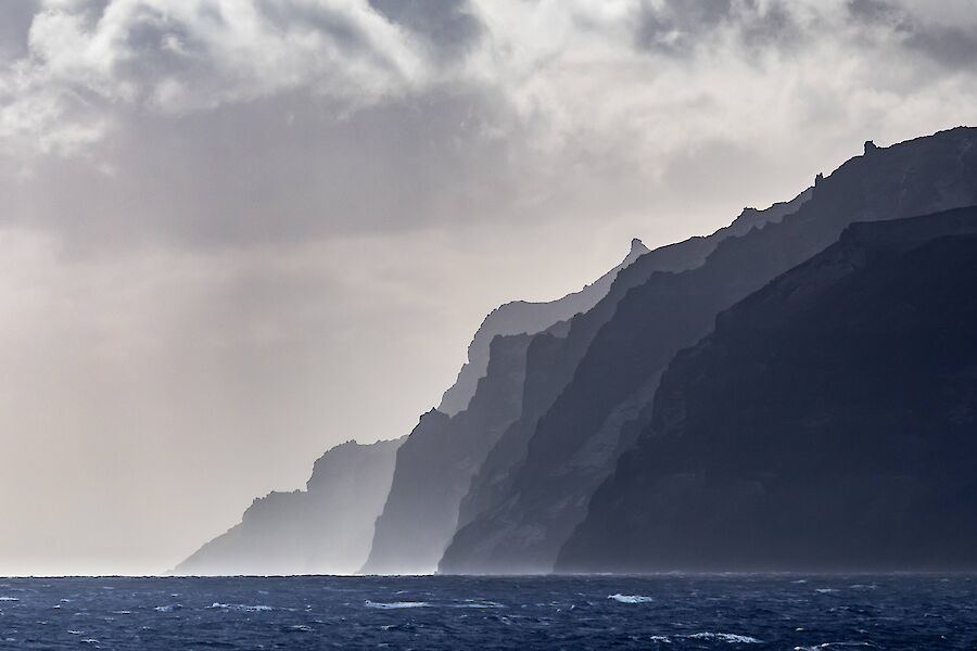 An atmospheric shot of island cliffs falling to the sea.
