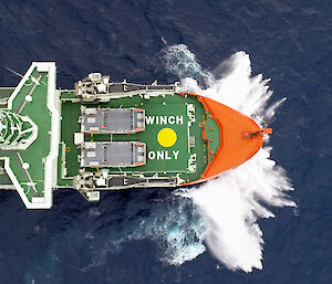 An aerial shot looking down on to the bow of a moving ship