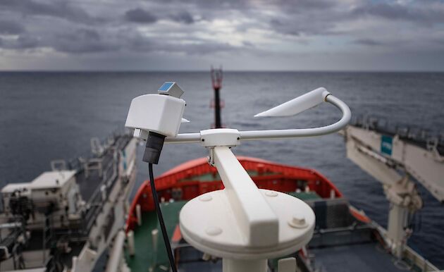 Some weather sensors looking out over the bow of a ship