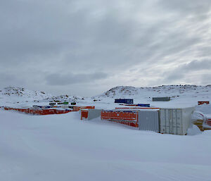 Snow covered buildings under a grey cloudy sky