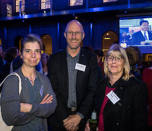 Three people smiling at the camera